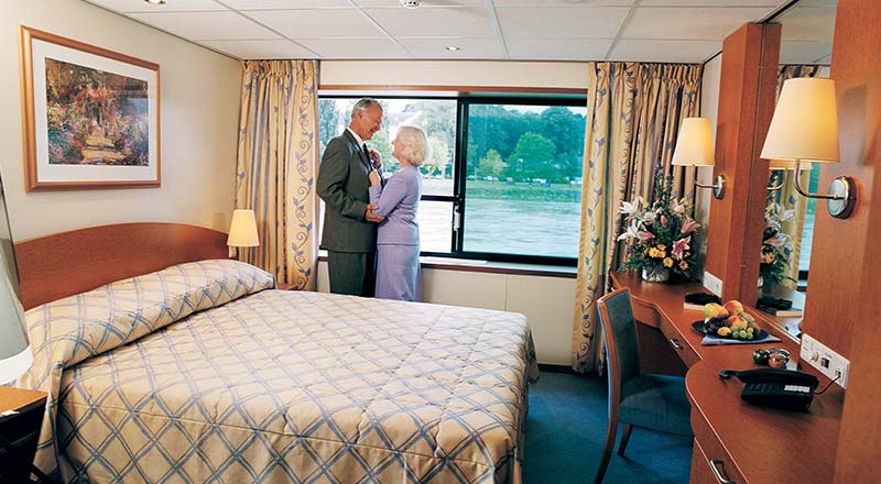 Couple inside deluxe stateroom